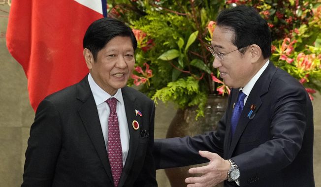 Japan&#x27;s Prime Minister Fumio Kishida, right, greets Philippines&#x27; President Ferdinand Marcos Jr. prior to their bilateral meeting at the prime minister&#x27;s official residence in Tokyo, Sunday, Dec. 17, 2023, on the sidelines of the Commemorative Summit for the 50th Year of ASEAN-Japan Friendship and Cooperation. The first-ever trilateral summit between President Joe Biden, Kishida and Philippine President Ferdinand Marcos Jr. comes as the Philippines faces escalating maritime tension with China over their contested South China Sea claims.(Franck Robichon/Pool Photo via AP) **FILE**