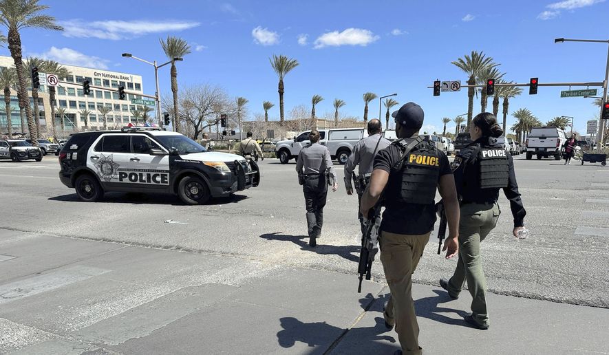 Law enforcement responds to a shooting Monday, April 8, 2024, at a law office in Las Vegas. (AP Photo/Ty ONeil)