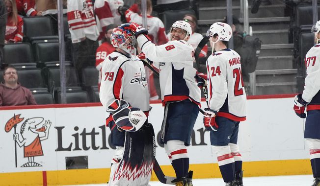 Washington Capitals left wing Alex Ovechkin (8) celebrates with goaltender Charlie Lindgren (79) as Connor McMichael (24) looks on after an NHL hockey game Tuesday, April 9, 2024, in Detroit. The Capitals beat the Red Wings 2-1. (AP Photo/Paul Sancya) **FILE**