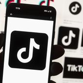 The TikTok logo is displayed on a mobile phone in front of a computer screen displaying the TikTok home screen, on Oct. 14, 2022, in Boston. An ex-TikTok worker’s claims of sharing U.S. user data with counterparts in Beijing has rattled the company as it works feverishly to avoid a ban in America. (AP Photo/Michael Dwyer, File)