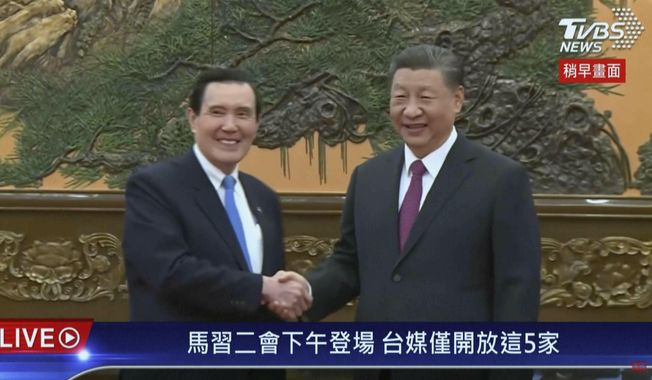 In this image taken from video by Taiwan&#x27;s TVBS, Chinese President Xi Jinping at right meets with former Taiwanese President Ma Ying-jeou in Beijing on Wednesday, April 10, 2024 in a bid to promote unification between the sides that separated amid civil war in 1949. (TVBS via AP)
