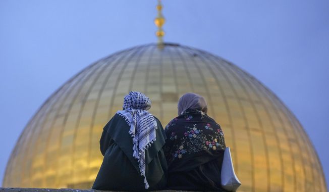 Palestinians gather for Eid al-Fitr prayers by the Dome of the Rock shrine in the Al Aqsa Mosque compound in Jerusalem&#x27;s Old City, Wednesday, April 10, 2024. The holiday marks the end of the holy month of Ramadan, when devout Muslims fast from sunrise to sunset. (AP Photo/Mahmoud Illean)
