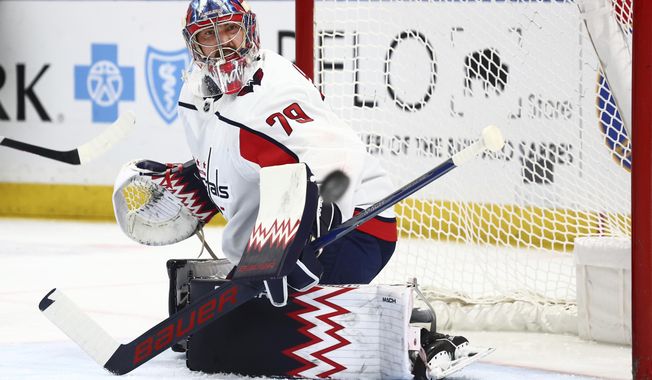 Washington Capitals goaltender Charlie Lindgren (79) watches the puck go wide during the first period of an NHL hockey game against the Buffalo Sabres, Thursday, April 11, 2024, in Buffalo, N.Y. (AP Photo/Jeffrey T. Barnes)