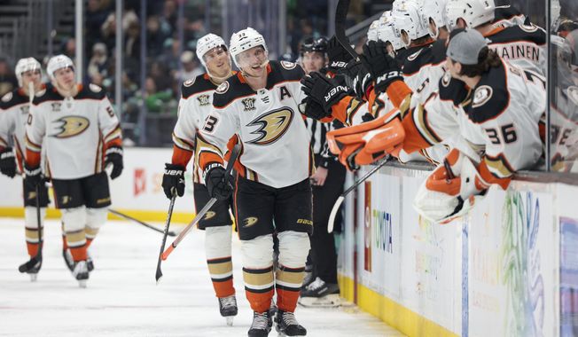 Anaheim Ducks right wing Jakob Silfverberg, center, is congratulated for a shorthanded goal during the third period of the team&#x27;s NHL hockey game against the Seattle Kraken on Thursday, March 28, 2024, in Seattle. The Kraken won 4-2. (AP Photo/Jason Redmond)