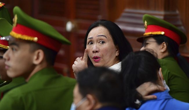 Business woman Truong My Lan, center, attends a trial in Ho Chi Minh City, Vietnam on Thursday, April 11, 2024. The real estate tycoon may face the death penalty if convicted of allegations that she siphoned off an amount of $12.5 billion, nearly 3 percent of Vietnam&#x27;s 2022 GDP, in its largest financial fraud case. (Thanh Tung/VnExpress via AP)