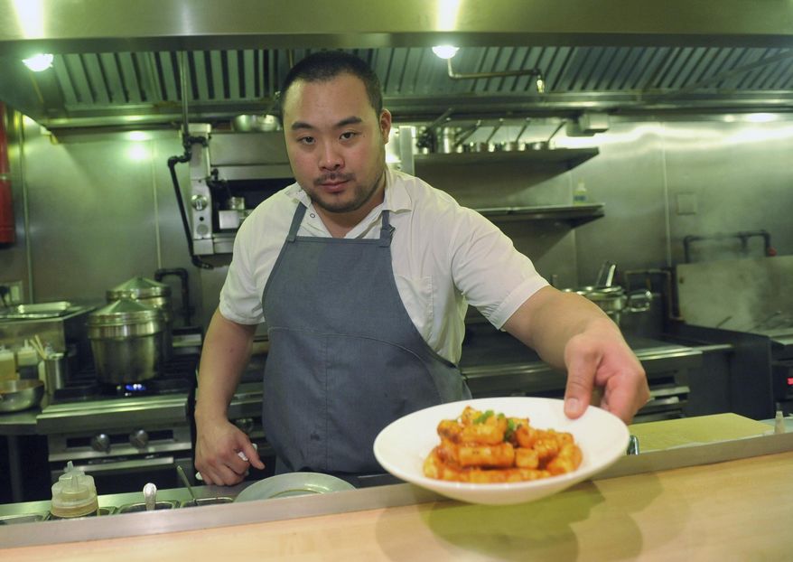 David Chang presents a dish at Momofuku Noodle Bar in New York on Thursday, Nov. 10, 2011. On Friday, April 12, 2024, Momofuku, a food and restaurant brand started by food mogul Chang, said it won't defend its trademark on the name “chile crunch” after it sparked an outcry by sending cease-and-desist letters to other businesses using the term. (AP Photo/Diane Bondareff, File)