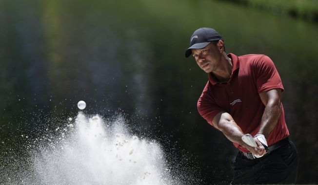 Tiger Woods hits from the bunker on the 16th hole during final round at the Masters golf tournament at Augusta National Golf Club Sunday, April 14, 2024, in Augusta, Ga. (AP Photo/Charlie Riedel). **FILE**