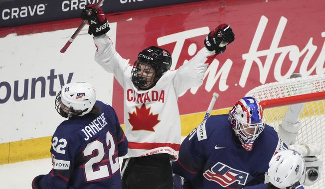 Canada&#x27;s Danielle Serdachny (92) celebrates the goal by teammate Marie-Philip Poulin, not shown, over United States goaltender Aerin Frankel (31) during the second period in the final at the IIHF Women&#x27;s World Hockey Championships in Utica, N.Y., Sunday, April 14, 2024. (Christinne Muschi/The Canadian Press via AP)