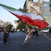 Demonstrators wave a huge Iranian flag in their anti-Israeli gathering in front of an anti-Israeli banner on the wall of a building at the Felestin (Palestine) Square in Tehran, Iran, Monday, April 15, 2024. World leaders are urging Israel not to retaliate after Iran launched an attack involving hundreds of drones, ballistic missiles and cruise missiles. The sign on the banner reads in Hebrew: &quot;Your next mistake will be the end of your fake country.&quot; And the sign in Farsi reads: &quot;The next slap will be harder.&quot; (AP Photo/Vahid Salemi) **FILE**