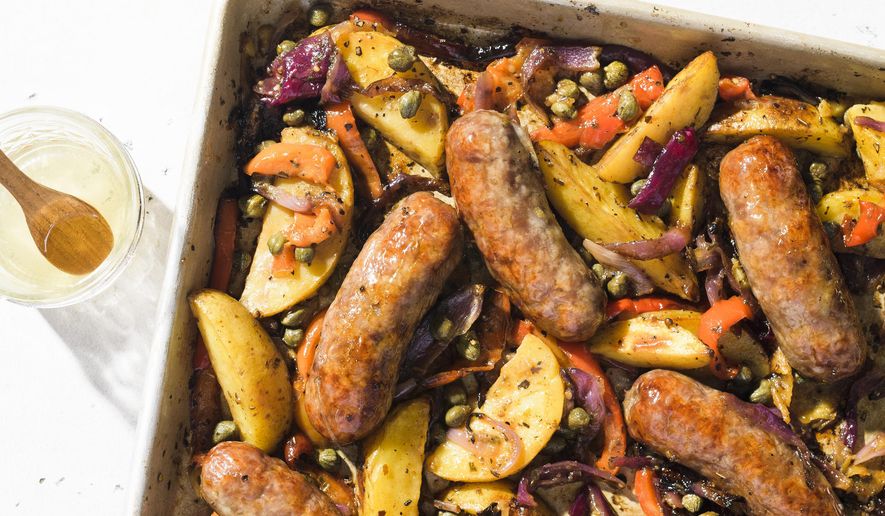 This image released by Milk Street shows a recipe for sausage and potato traybake. (Milk Street via AP)