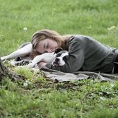 A woman and her dog nap between rain showers at Schenley Park, Tuesday, May 4, 2021, in Pittsburgh. A Gallup survey, released Monday, April 15, 2024, says that a majority of Americans say they would feel better if they could have more sleep. But in the U.S., where the ethos of grinding and pulling yourself up by your own bootstraps is ubiquitous, getting enough sleep can seem like a dream. (Pam Panchak/Pittsburgh Post-Gazette via AP, File)