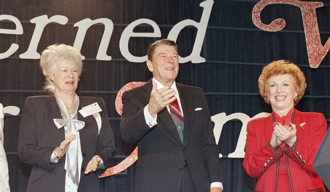 President Ronald Reagan is applauded by Beverly LaHaye, president of Concerned Women for America, right, shortly before he addressed the group in Arlington, Va., Sept. 25, 1987. (AP Photo/Scott Stewart) ** FILE **
