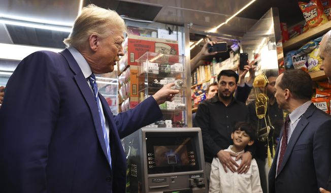 Former president Donald Trump talks with bodega owner Maad Ahmed, center, during a visit to his store, Tuesday, April 16, 2024, in New York. Fresh from a Manhattan courtroom, Donald Trump visited a New York bodega where a man was stabbed to death, a stark pivot for the former president as he juggles being a criminal defendant and the Republican challenger intent on blaming President Joe Biden for crime. (AP Photo/Yuki Iwamura)