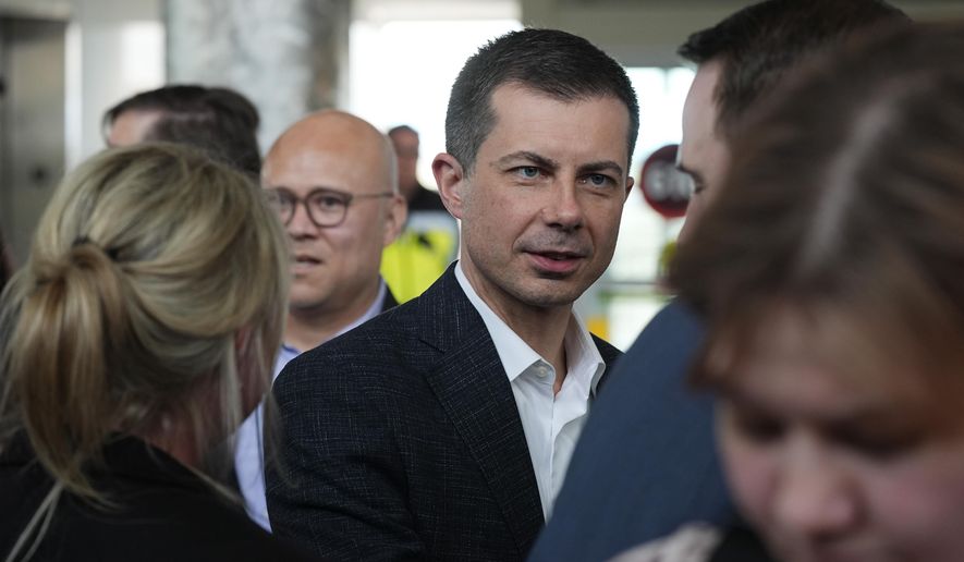 U.S. Transportation Secretary Pete Buttigieg, center, greets well-wishers after a news conference to announce on Tuesday, April 16, 2024, in Denver. (AP Photo/David Zalubowski)