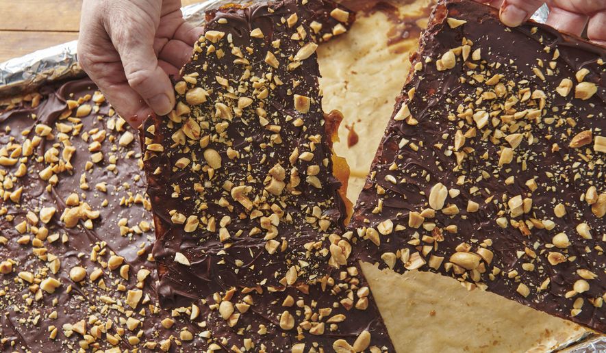 This photo shows chocolate toffee covered matzoh. Chocolate-covered caramel matzo, also known as Matzoh Buttercrunch, has become a popular Passover dessert. (Cheyenne Cohen via AP).