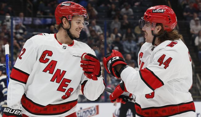 Carolina Hurricanes&#x27; Jesperi Kotkaniemi, left, and Maxime Comtois celebrate their goal against the Columbus Blue Jackets during the first period of an NHL hockey game Tuesday, April 16, 2024, in Columbus, Ohio. (AP Photo/Jay LaPrete)