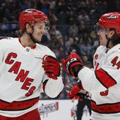 Carolina Hurricanes&#x27; Jesperi Kotkaniemi, left, and Maxime Comtois celebrate their goal against the Columbus Blue Jackets during the first period of an NHL hockey game Tuesday, April 16, 2024, in Columbus, Ohio. (AP Photo/Jay LaPrete)