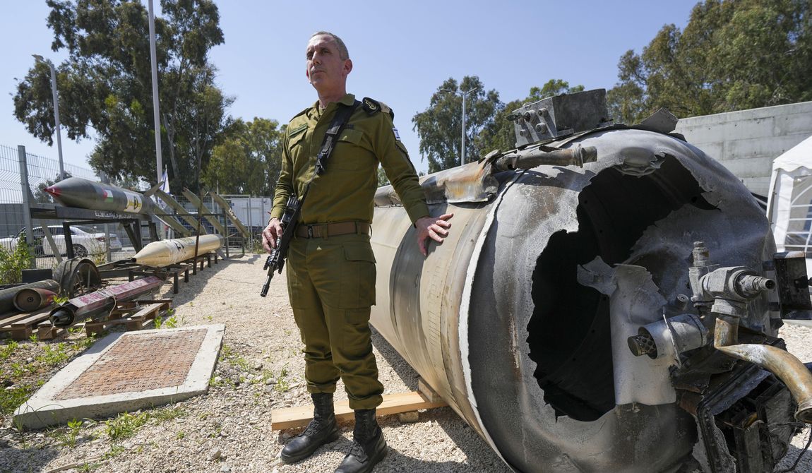Israeli military spokesperson, Rear Adm. Daniel Hagari, displays to the media one of the Iranian ballistic missiles that Israel intercepted over the weekend, in Julis army base, southern Israel, Tuesday, April 16, 2024. (AP Photo/Tsafrir Abayov)