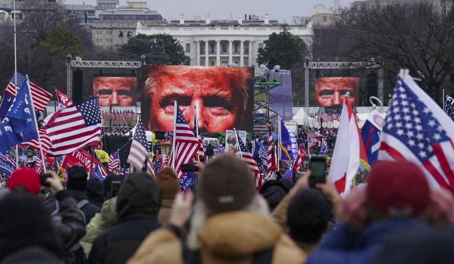 FILE - Supporters of Donald Trump participate in a rally in Washington, Jan. 6, 2021. The Supreme Court is hearing arguments Tuesday, April 16, 2024, over the charge of obstruction of an official proceeding that has been brought against 330 people, according to the Justice Department. The charge refers to the disruption of Congress' certification of Joe Biden's 2020 presidential election victory over former President Trump. Trump faces two obstruction charges. Next week, the justices will weigh whether Trump can be prosecuted at all for his efforts to overturn the 2020 election results. (AP Photo/John Minchillo, File)