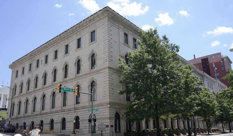 A pedestrian passes by the U.S. 4th Circuit Court of Appeals Courthouse on Main Street in Richmond, Va., Wednesday, June 16, 2021. (AP Photo/Steve Helber, File)