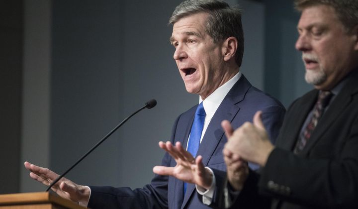 North Carolina Gov. Roy Cooper, left, answers questions at a news conference in which he declared a state of emergency for North Carolina, March 10, 2020. Cooper’s decisions during the COVID-19 pandemic that resulted in bars being shuttered or severely restricted while restaurants that served alcohol could reopen were &quot;illogical&quot; and don&#x27;t appear justified by evidence, a state appeals court ruled Tuesday, April 16, 2024. (Julia Wall/The News &amp; Observer via AP, File)