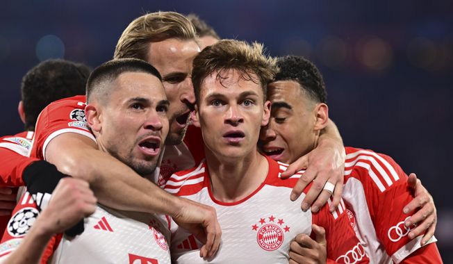 Bayern&#x27;s Joshua Kimmich, centre, celebrates with teammates after scoring his side&#x27;s opening goal during the Champions League quarter final second leg soccer match between Bayern Munich and Arsenal at the Allianz Arena in Munich, Germany, Wednesday, April 17, 2024. (AP Photo/Christian Bruna)