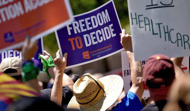 Abortion rights supporters gather outside the Capitol, Wednesday, April 17, 2024, in Phoenix. (AP Photo/Matt York)