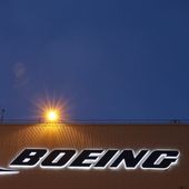 An airplane flies over a sign on Boeing&#x27;s 737 delivery center, Oct. 19, 2015, at Boeing Field in Seattle. (AP Photo/Ted S. Warren, File)
