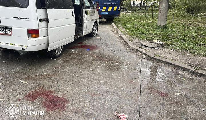 In this photo provided by the Ukrainian Emergency Service, blood is seen next to a car damaged by Russian missile strike in Chernihiv, Ukraine, Wednesday, April 17, 2024. (Ukrainian Emergency Service via AP Photo)