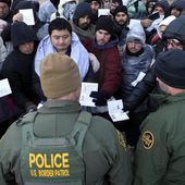 Border Patrol agents ask asylum-seeking migrants to line up in a makeshift, mountainous campsite after the group crossed the border with Mexico,Feb. 2, 2024, near Jacumba Hot Springs, Calif. (AP Photo/Gregory Bull, File)