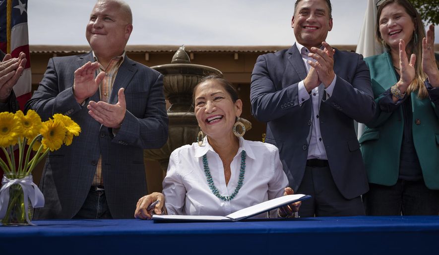 Interior Secretary Deb Haaland smiles after signing Public Land Order 7940, which protects more than 4,200 acres of Bureau of Land Management-managed public lands that is sacred to Tribes in the Placitas area, during a community event at El Zócalo Plaza in Bernalillo, N.M., Thursday, April 18, 2024. For the next 50 years, the lands will be closed to new mining claims, mineral sales, and oil and gas leases. (Chancey Bush/The Albuquerque Journal via AP)