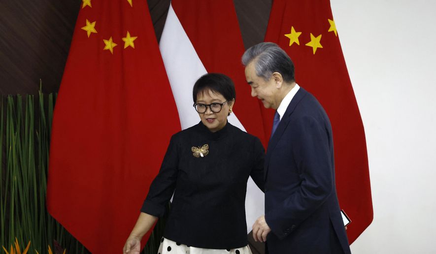 Chinese Foreign Minister Wang Yi, right, walks with Indonesian Foreign Minister Retno Marsudi during their bilateral meeting in Jakarta, Indonesia, Thursday, April 18, 2024. (Willy Kurniawan/Pool Photo via AP)