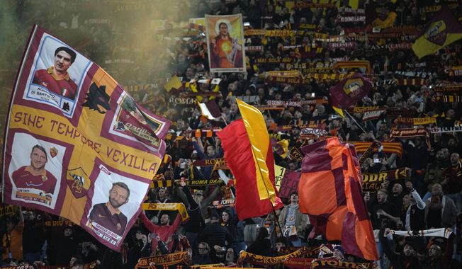 Fans of Roma cheer for their team prior to the start of the Europa League quarterfinal second leg soccer match between Roma and AC Milan, at Rome&#x27;s Olympic Stadium, Thursday, April 18, 2024. (AP Photo/Andrew Medichini)