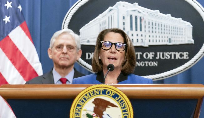 FILE - Deputy Attorney General Lisa Monaco speaks as Attorney General Merrick Garland listens during a news conference at Department of Justice headquarters in Washington, March 21, 2024. The Justice Department is ramping up its efforts to reduce violent crime in the U.S., launching a specialized gun intelligence center in Chicago and expanding task forces to curb carjackings. Deputy Attorney General Lisa Monaco tells The Associated Press there&#x27;s “absolutely much more to do” to make communities safer, even as many places have experienced a downward trend in crime after a coronavirus pandemic-era spike. (AP Photo/Jose Luis Magana)