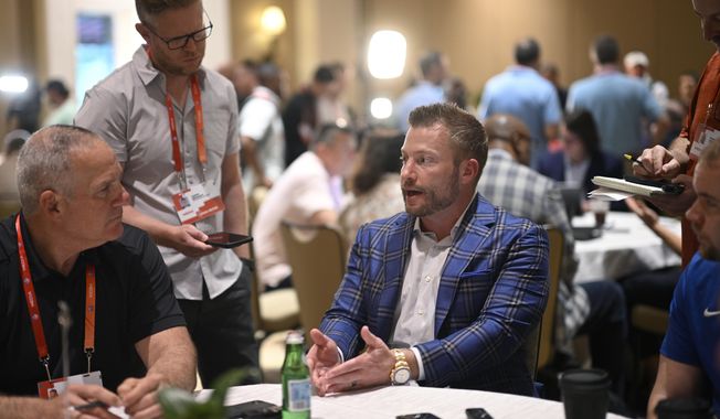 Los Angeles Rams head football coach Sean McVay, center, talks with reporters during an NFC coaches availability at the NFL owners meetings, Tuesday, March 26, 2024, in Orlando, Fla. (AP Photo/Phelan M. Ebenhack)