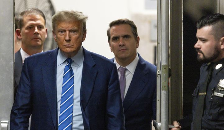 Former President Donald Trump walks through a doorway during the second day of jury selection, Tuesday, April 16, 2024, at Manhattan criminal court in New York. Trump is charged with falsifying business records to cover up a sex scandal during his 2016 campaign. (Justin Lane/Pool Photo via AP)