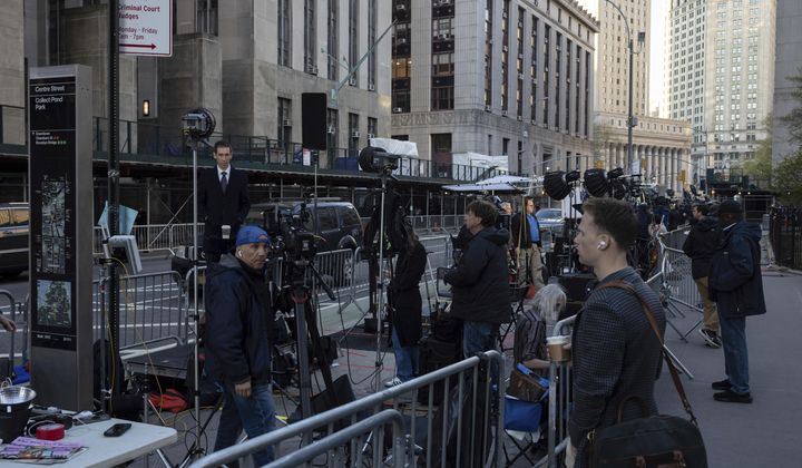 Members of the media gather outside Manhattan Criminal Court, Tuesday, April 16, 2024, in New York. Former President Donald Trump will return to court as a judge works to find a panel of jurors who will decide whether the former president is guilty of criminal charges alleging he falsified business records to cover up a sex scandal during the 2016 campaign. (AP Photo/Yuki Iwamura) **FILE**