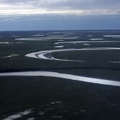 This July 8, 2004, photo provided by the United States Geological Survey shows Fish Creek through the National Petroleum Reserve-Alaska, managed by the Bureau of Land Management on Alaska&#x27;s North Slope. (David W. Houseknecht/United States Geological Survey via AP)
