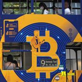 An advertisement for the cryptocurrency Bitcoin displayed on a tram, May 12, 2021, in Hong Kong. Sometime in the next few days or even hours, the “miners” who chisel bitcoins out of complex mathematics are going to take a 50% pay cut — effectively slicing new emissions of the world’s largest cryptocurrency in an event called bitcoin halving. (AP Photo/Kin Cheung, File)