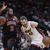 Miami Heat forward Kevin Love (42) drives to the basket against Chicago Bulls center Andre Drummond (3) during the first half of an NBA basketball play-in tournament game, Friday, April 19, 2024, in Miami. (AP Photo/Wilfredo Lee)