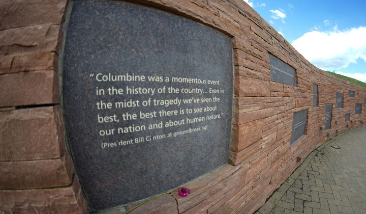 In this photo taken with fisheye lens, a plaque with a quote from President Bill Clinton is displayed on the wall of healing at the Columbine Memorial, April 17, 2024, in Littleton, Colo. The 12 students and a teacher killed in the Columbine High School shooting will be remembered Friday, April 19, 2024, in a vigil on the eve of the 25th anniversary of the tragedy. (AP Photo/David Zalubowski, File)