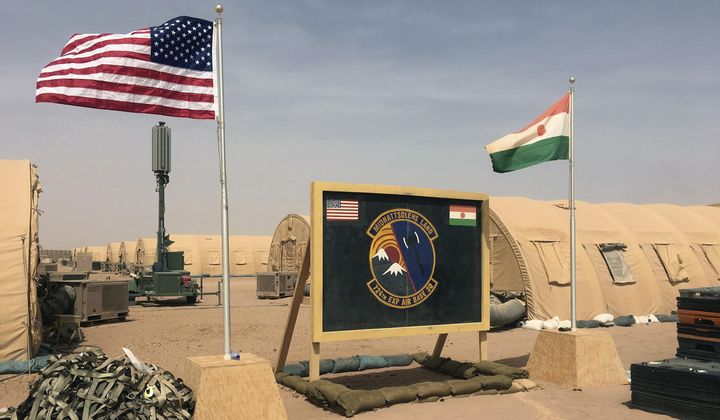 A U.S. and Niger flag are raised side by side at the base camp for air forces and other personnel supporting the construction of Niger Air Base 201 in Agadez, Niger, April 16, 2018. The United States is attempting to create a new military agreement with Niger that would allow it to remain in the country, weeks after the junta said its presence was no longer justified, two Western officials told The Associated Press Friday April 19, 2024. (AP Photo/Carley Petesch, File)