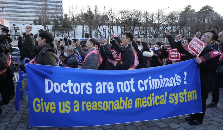 Doctors stage a rally against the government&#x27;s medical policy near the presidential office in Seoul, South Korea, on Feb. 25, 2024. Desperate to end a weekslong strike by thousands of doctors, South Korea’s government said Friday it will slow down a plan to admit thousands more students to the country&#x27;s medical schools from next year. (AP Photo/Ahn Young-joon, File)
