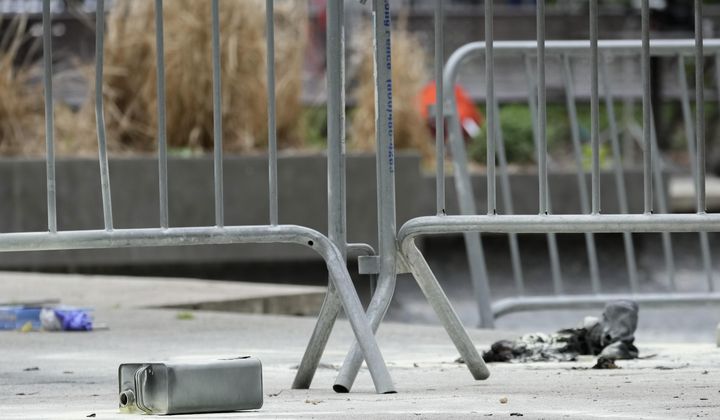 A metal can sits on the ground at the scene where a man lit himself on fire in a park outside Manhattan criminal court, Friday, April 19, 2024, in New York. Emergency crews rushed away a person on a stretcher after fire was extinguished outside the Manhattan courthouse where jury selection was taking place Friday in Donald Trump&#x27;s hush money criminal case. (AP Photo/Mary Altaffer)