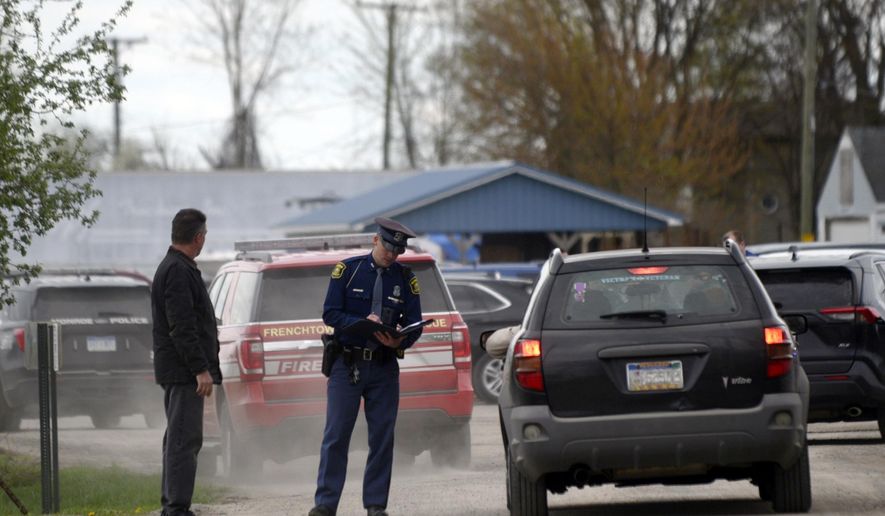 A law enforcement official monitors the perimeter of the Swan Creek Boat Club after a driver crashed a vehicle through a building where a children&#x27;s birthday party was taking place, Saturday, April 20, 2024, in Berlin Township, Mich. (Kathleen Kildee/Detroit News via AP)