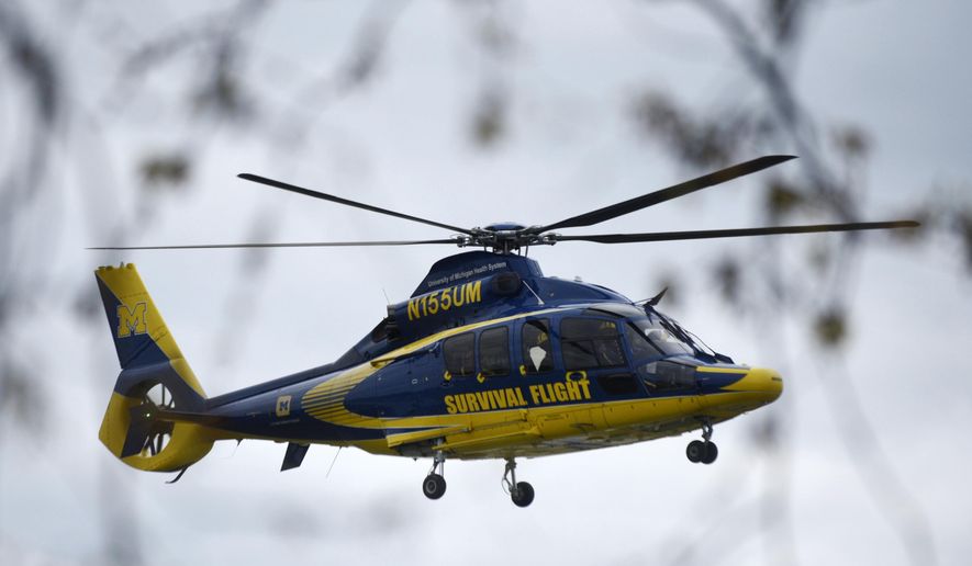 A University of Michigan Health Systems Survival Flight responds to the Swan Creek Boat Club after a driver crashed a vehicle through a building where a children&#x27;s birthday party was taking place, Saturday, April 20, 2024, in Berlin Township, Mich. (Kathleen Kildee/Detroit News via AP)