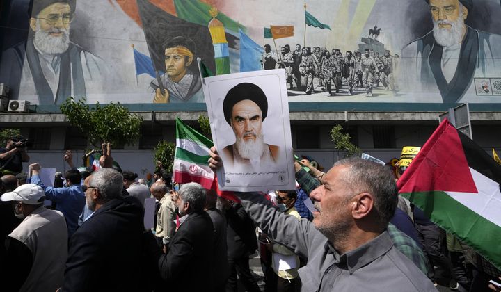 Iranian worshippers walk past a mural showing the late revolutionary founder Ayatollah Khomeini, right, Supreme Leader Ayatollah Ali Khamenei, left, and Basij paramilitary force, as they hold posters of Ayatollah Khomeini and Iranian and Palestinian flags in an anti-Israeli gathering after Friday prayers in Tehran, Iran, April 19, 2024. This month&#x27;s unprecedented direct attacks between Iran and Israel are revealing deeper insights into both militaries. Experts say Friday&#x27;s apparent precision strike by Israel deep into Iran demonstrated Israel&#x27;s military dominance on almost all fronts. (AP Photo/Vahid Salemi, File)