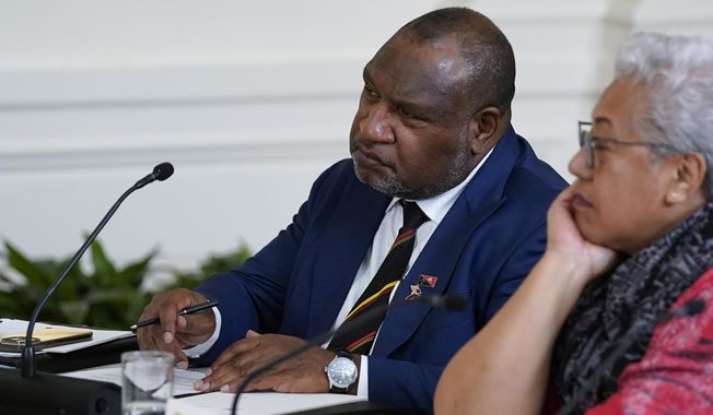 Papua New Guinean Prime Minister James Marape, left, listens during a meeting with Pacific Islands Forum leaders during the U.S.-Pacific Islands Forum Summit in the East Room of the White House, Monday, Sept. 25, 2023, in Washington. Marape accused Joe Biden of disparaging the South Pacific island nation by implying that an uncle of the U.S. president had been eaten by “cannibals” there during World War II. (AP Photo/Evan Vucci, File)