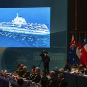 A screen shows a Chinese aircraft carrier at the opening of the Western Pacific Navy Symposium in Qingdao, eastern China&#x27;s Shandong province on Monday, April 22, 2024. Zhang Youxia, one of China&#x27;s top military leaders took a harsh line on regional territorial disputes, telling an international naval gathering in northeastern China on Monday that the country would strike back with force if its interests came under threat. (AP Photo/Ng Han Guan)