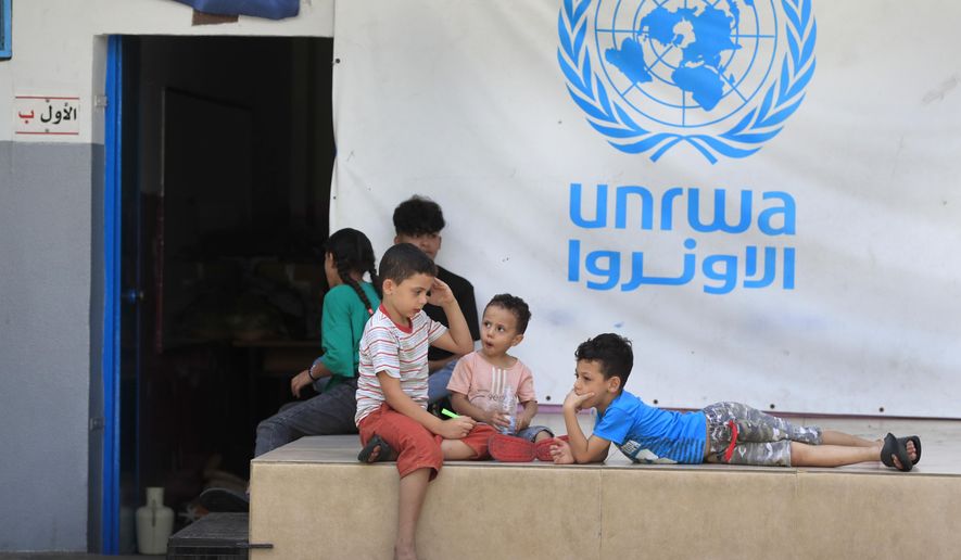 Palestinian children who fled with their parents from their houses in the Palestinian refugee camp of Ein el-Hilweh, gather in the backyard of a UNRWA school, in Sidon, Lebanon, Sept. 12, 2023. An independent review released Monday, April 22, 2024, of the neutrality of UNRWA, the U.N. agency helping Palestinian refugees, has found that Israel never expressed concern about anyone on the staff lists it has received annually since 2011. The review was carried out after Israel alleged that a dozen employees of the agency had participated in Hamas’ Oct. 7 attacks. (AP Photo/Mohammed Zaatari, File)